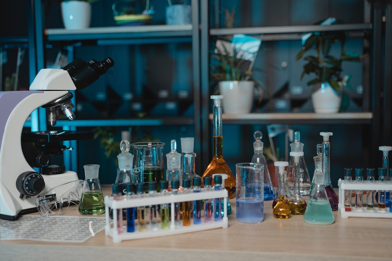 Vibrant laboratory setup with glassware, colored liquids, and a microscope for scientific research.